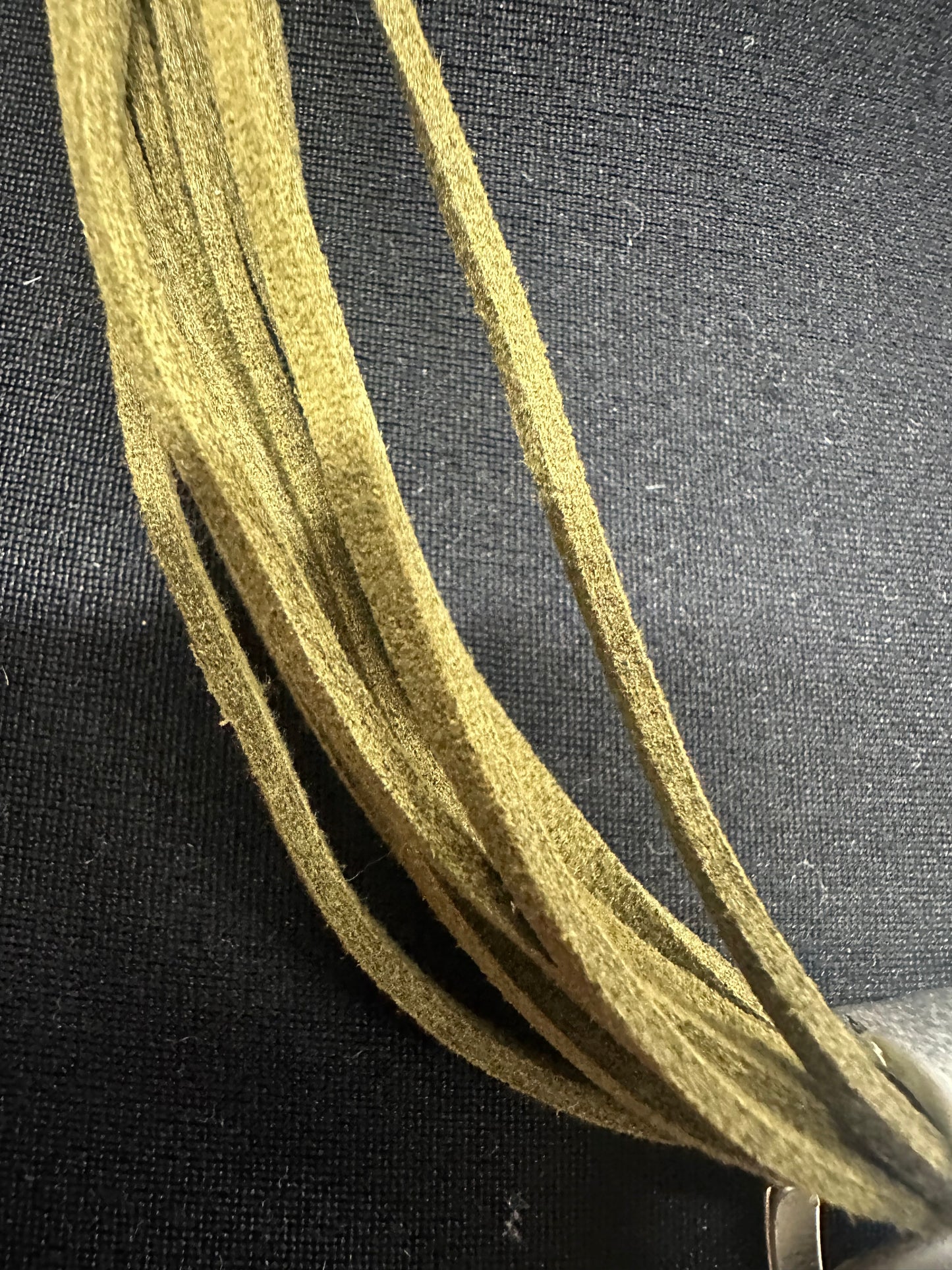 Statement brushed silver metal neckpiece with soft suede olive green collar